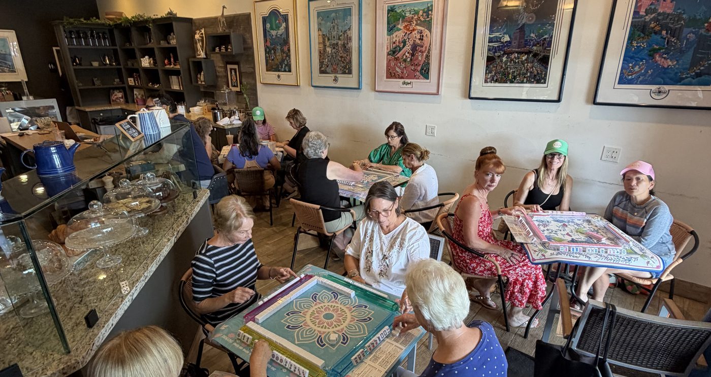 Women playing American Mahjong at a bakery social event hosted by Au Mahj Group